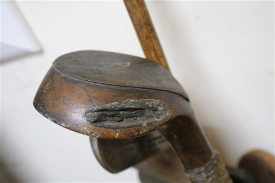 Two wooden drivers by Armstrong & Co and Paxton, a gun metal putto signed Jacques, 7 other and a golf ball